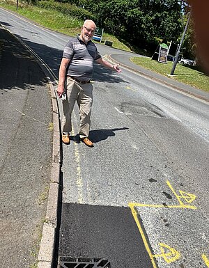 Councillor John Nutley inspects road repairs