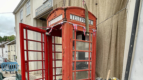 The red telephone box being removed from The Square, North Tawton