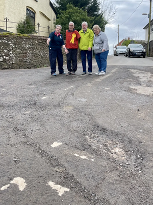 Frank Letch and local Bow residents examine road surface