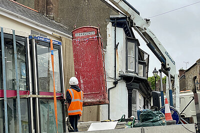 The red telephone box being removed from The Square, North Tawton